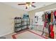 This bedroom includes shelves for storage, a ceiling fan, neutral colored walls, and a window to allow natural light in at 12303 Waldrop Pl, Decatur, GA 30034