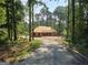 New construction home under construction in a wooded area, surrounded by trees and nature at 2043 Fischer Rd, Sharpsburg, GA 30277