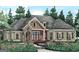 Charming one-story home with stone accents, lush landscaping, and a welcoming entrance at 2043 Fischer Rd, Sharpsburg, GA 30277