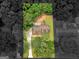 Aerial view of a home with a large lot surrounded by mature trees and a long driveway at 90 Country Roads Cir, Stockbridge, GA 30281