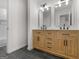 Modern bathroom featuring a wooden double sink vanity, black tile floors, and a walk-in shower at 90 Country Roads Cir, Stockbridge, GA 30281