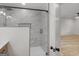 Bathroom featuring a glass shower enclosure, white marble tile, and view into an adjacent bedroom at 90 Country Roads Cir, Stockbridge, GA 30281