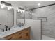 Modern bathroom features a double sink vanity with marble countertop and a glass enclosed shower with white marble tiling at 90 Country Roads Cir, Stockbridge, GA 30281