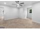 Spacious bedroom featuring neutral carpet, a ceiling fan, a window, and entry to an adjacent room at 90 Country Roads Cir, Stockbridge, GA 30281
