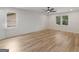 Large bedroom features hardwood floors, two windows, and a ceiling fan at 90 Country Roads Cir, Stockbridge, GA 30281
