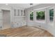 Dining room features built-in cabinets, hardwood floors, large bay window, and pendant lighting at 90 Country Roads Cir, Stockbridge, GA 30281