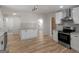 Bright kitchen with white cabinets, subway tile backsplash, stainless steel appliances, and eat-in breakfast bar at 90 Country Roads Cir, Stockbridge, GA 30281