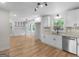 Eat-in kitchen featuring white cabinets, stainless steel appliances, and light-colored wood floors at 90 Country Roads Cir, Stockbridge, GA 30281