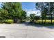 Spacious property with a long driveway, black fencing, lush lawns and mature trees at 110 Green Meadow Ln, Fayetteville, GA 30215