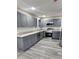 Modern kitchen featuring gray cabinetry, stainless steel appliances, and granite countertops at 4059 Canby Ln, Decatur, GA 30035