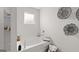 Bright bathroom featuring a soaking tub with decorative accents and a window for natural light at 5455 Baybrook Cir, South Fulton, GA 30349
