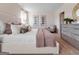 Elegant bedroom featuring neutral bedding, stylish artwork, and a comfy armchair at 5455 Baybrook Cir, South Fulton, GA 30349