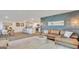 Open-concept living space with modern décor, a stylish sofa, and hardwood floors at 5455 Baybrook Cir, South Fulton, GA 30349