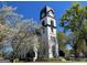 Tall white clock tower against a blue sky surrounded by blooming trees at 482 N Jeff Davis Dr, Fayetteville, GA 30214