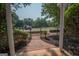 Exterior view from the porch looking over the landscaped yard and black metal fence at 482 N Jeff Davis Dr, Fayetteville, GA 30214