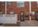 Charming brick facade with well-maintained entrance and white picket fence detail, unit 482 at 482 N Jeff Davis Dr, Fayetteville, GA 30214