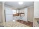 Well-lit kitchen featuring white cabinets, granite countertops, and modern appliances at 482 N Jeff Davis Dr, Fayetteville, GA 30214