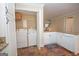 Bright kitchen with laundry, stone floors, granite counters and white cabinets at 482 N Jeff Davis Dr, Fayetteville, GA 30214
