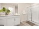 Bright bathroom featuring double vanity, framed mirror, and glass-enclosed shower at 5451 Baybrook Cir, South Fulton, GA 30349