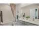 Well-lit bathroom with double sinks and a bathtub with shower, perfect for relaxing at 5451 Baybrook Cir, South Fulton, GA 30349