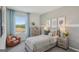 Comfortable bedroom featuring a bed with baseball pillows, a window with view and side tables with lamps at 5451 Baybrook Cir, South Fulton, GA 30349