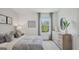 Comfortable bedroom with a large window, neutral decor, and soft, plush bedding at 5451 Baybrook Cir, South Fulton, GA 30349