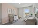 Charming Bedroom featuring soft pink and gray tones, a crib, and a comfortable rocking chair at 5451 Baybrook Cir, South Fulton, GA 30349