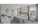 Bright primary bedroom featuring a king bed, side tables, and two windows with lovely outdoor views at 5451 Baybrook Cir, South Fulton, GA 30349