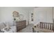 Cozy Bedroom with changing table, crib, and a comfortable armchair, perfect for a new baby at 5451 Baybrook Cir, South Fulton, GA 30349