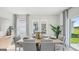 Bright and airy dining room featuring modern decor, a stylish table setting, and large windows at 5451 Baybrook Cir, South Fulton, GA 30349