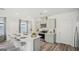 Kitchen area showcasing an island with barstool seating, quartz countertops, stainless steel appliances and light gray cabinetry at 5451 Baybrook Cir, South Fulton, GA 30349