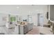 Bright, open-concept living area with a kitchen island, comfortable seating, and large windows with natural light at 5451 Baybrook Cir, South Fulton, GA 30349