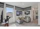 Fun living room with gray sofa and ottoman, movie posters, and a telescope, perfect for entertaining at 5451 Baybrook Cir, South Fulton, GA 30349