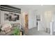 Upstairs loft with a sofa, striped accent wall, views of other rooms, and carpet floors at 5451 Baybrook Cir, South Fulton, GA 30349