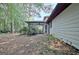 Backyard with trees and a screened in porch and patio at 212 Garret Rdg, Peachtree City, GA 30269