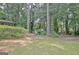 Lush backyard featuring mature trees and a well-maintained lawn, providing a serene outdoor space at 212 Garret Rdg, Peachtree City, GA 30269