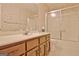 Bathroom featuring marble countertop vanity, toilet, and shower-tub combo with glass doors at 212 Garret Rdg, Peachtree City, GA 30269