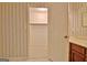 Bathroom featuring wallpaper design, vanity, and an open doorway to a closet at 212 Garret Rdg, Peachtree City, GA 30269