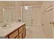 Bathroom featuring marble countertop vanity, toilet, and shower-tub combo with glass doors at 212 Garret Rdg, Peachtree City, GA 30269