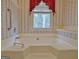 Relaxing tub in a bathroom with wallpaper, a window view, and grab bar for accessibility at 212 Garret Rdg, Peachtree City, GA 30269