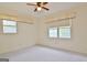 Bright bedroom with ceiling fan, windows, and neutral carpet offers a cozy retreat at 212 Garret Rdg, Peachtree City, GA 30269