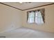 Bedroom showcasing patterned wallpaper, window, and neutral carpet at 212 Garret Rdg, Peachtree City, GA 30269