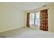 Sunlit bedroom featuring window with curtains, neutral carpet and white walls at 212 Garret Rdg, Peachtree City, GA 30269