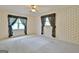 Spacious bedroom features patterned wallpaper, ceiling fan, and curtains at 212 Garret Rdg, Peachtree City, GA 30269