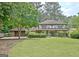 Traditional home with a spacious front yard, lush greenery, and a two-car garage at 212 Garret Rdg, Peachtree City, GA 30269