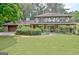 Charming home featuring Tudor-style architecture and a well-manicured lawn at 212 Garret Rdg, Peachtree City, GA 30269