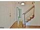 Inviting foyer with hardwood floors, staircase, and classic lighting fixture at 212 Garret Rdg, Peachtree City, GA 30269
