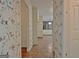 Hallway featuring tiled flooring and unique wallpaper, leading to other areas of the home at 212 Garret Rdg, Peachtree City, GA 30269