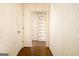 Hallway with wood flooring and wallpapered walls leading to rooms within the house at 212 Garret Rdg, Peachtree City, GA 30269