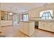 Traditional kitchen with an island, white cabinets, and tile floors at 212 Garret Rdg, Peachtree City, GA 30269